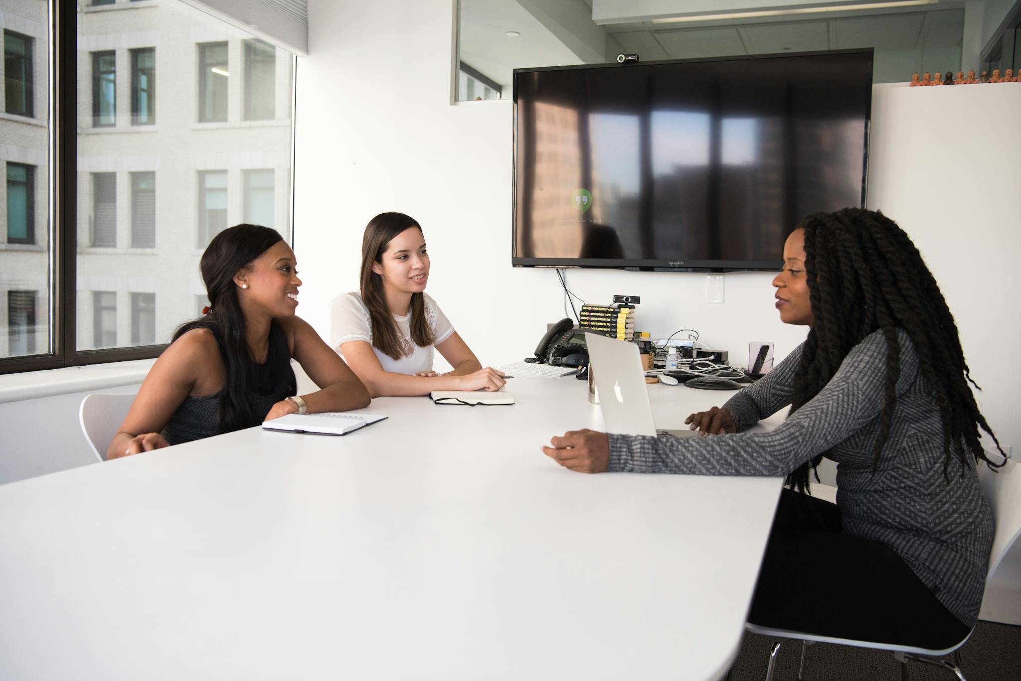 three women collaborate in a modern office